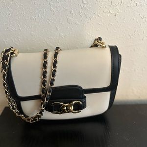 Black and cream medium sized purse. Has gold hardware.